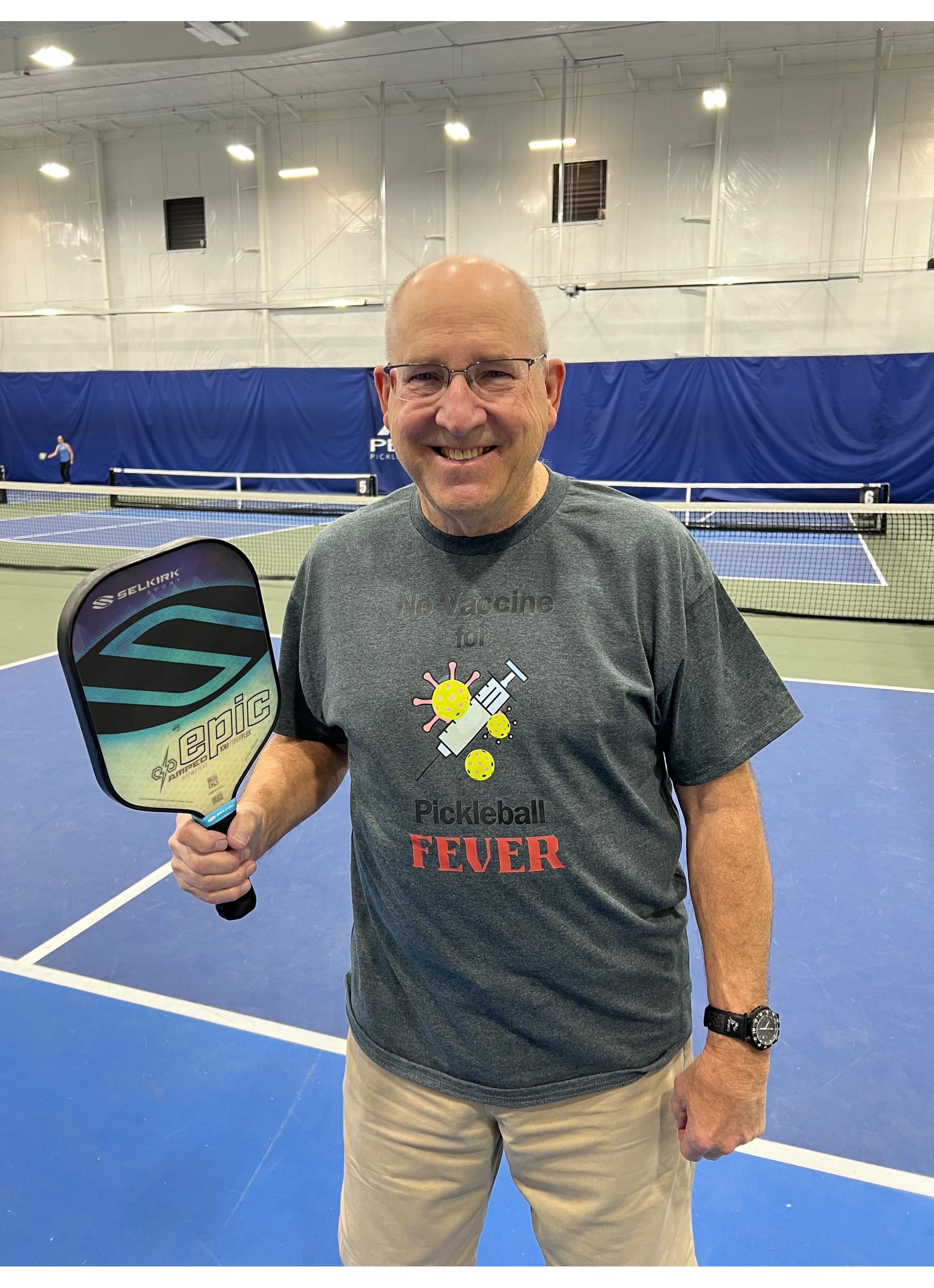 Ken posting in a Pickleball T-shirt with words and image There is No Vaccine for Pickleball Fever